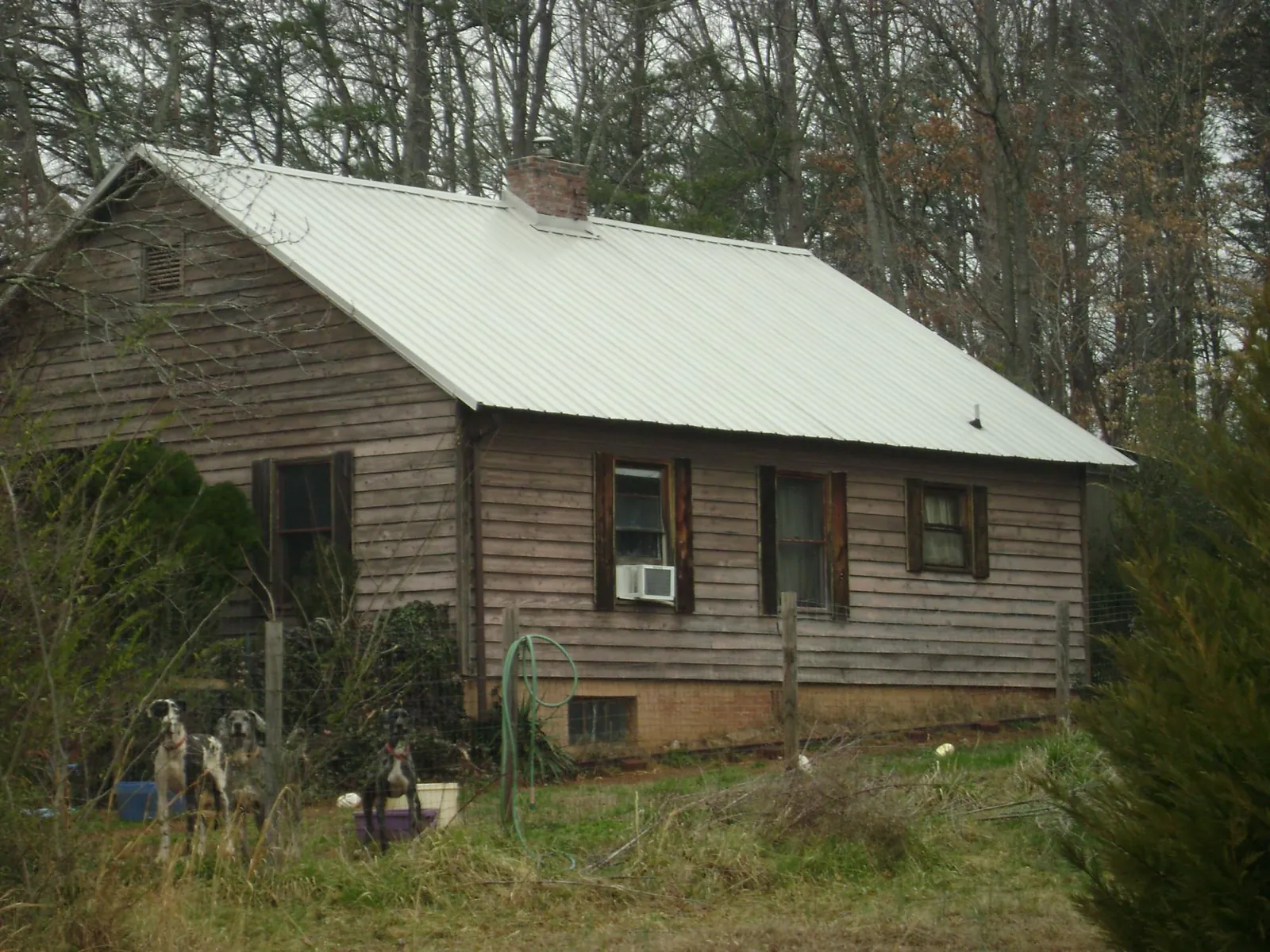 White metal roof on an old wood sided farmhouse, from a Metal Roof Installation job in Guilford